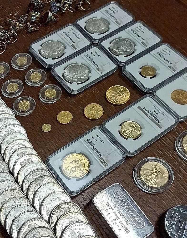 An estate coin collection graded through piece by piece — NGC slabs, gold and silver coins
