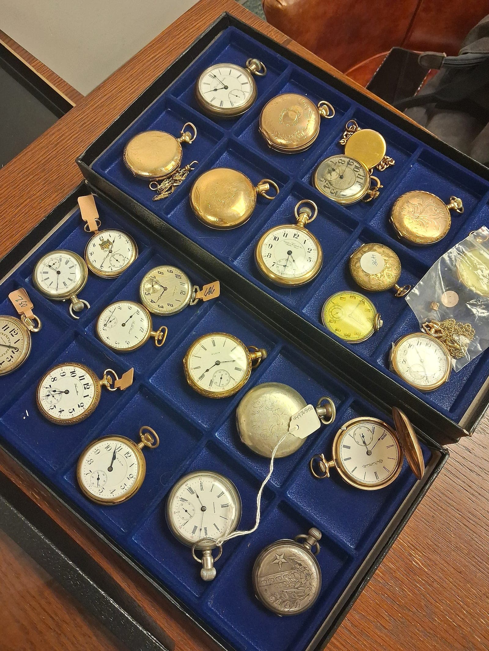 A cased collection of gold pocket watches from an estate